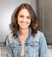 A woman smiling at the camera, wearing a shirt, embodying the positive and healthy lifestyle promoted by WeNatal.
